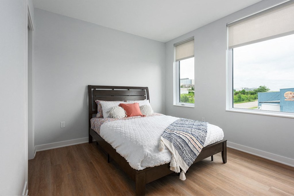 bedroom with plank flooring and large windows bedroom with plank flooring and large windows at Steelcote Square, St. Louis, 63103