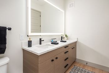 a bathroom with a sink and a mirror at Bemiston Place Apartments, Clayton, MO