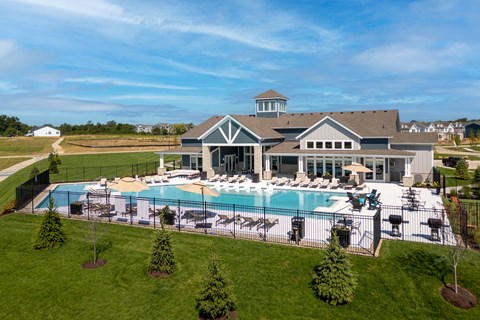A large house with a pool in the backyard.