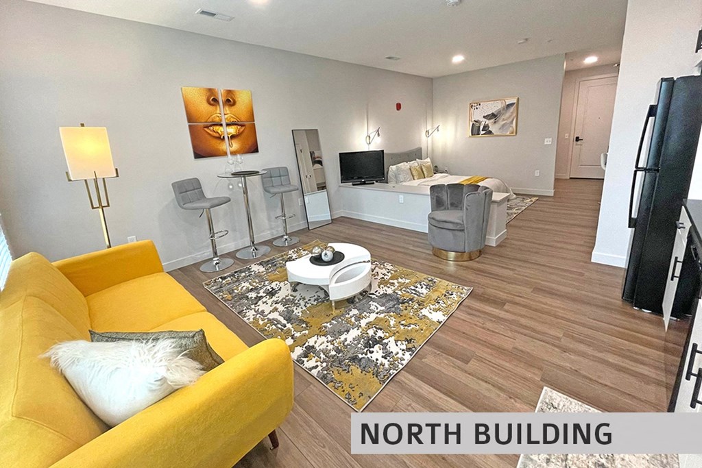 a living room with a yellow couch and a yellow chair  at Expo at Forest Park, St. Louis, Missouri