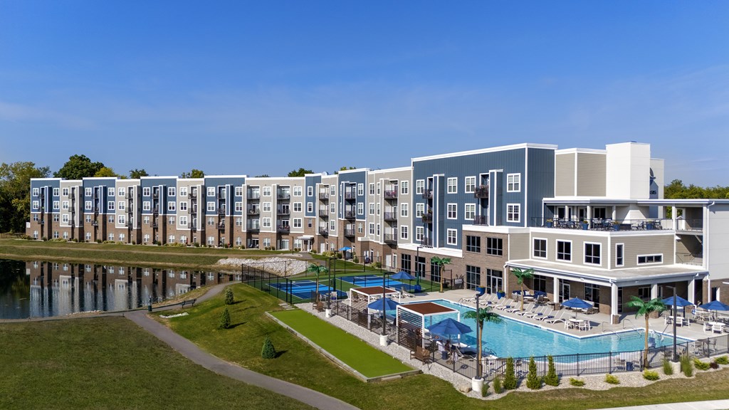 A large building with a pool in front of it.