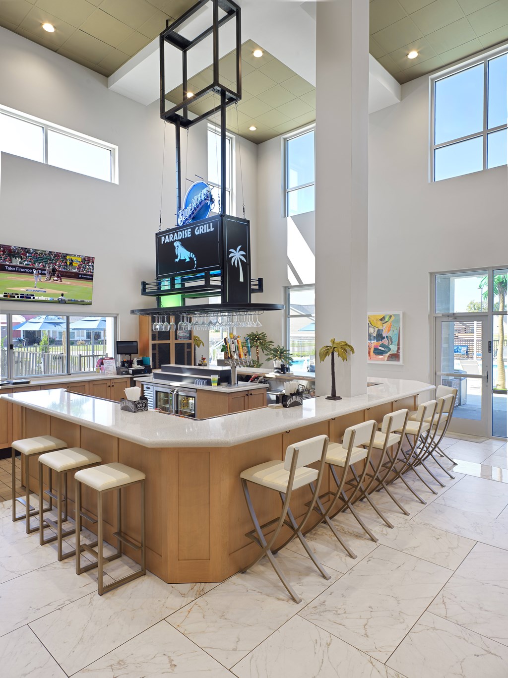 A bar area with a television screen showing a baseball game.