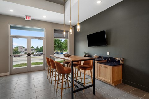 A modern dining room with a wooden table and chairs at The Oliver Apartments, Olivette