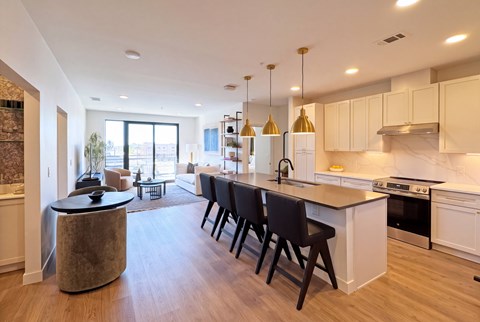 A modern kitchen with a large island and bar stools.