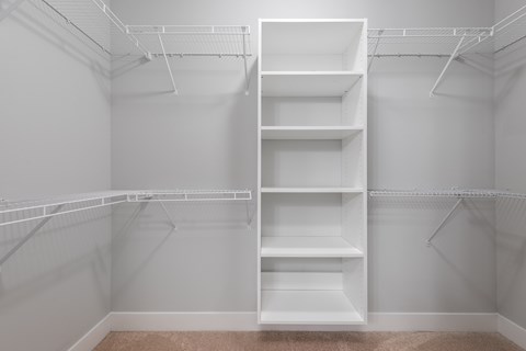 Empty white shelves in a room.