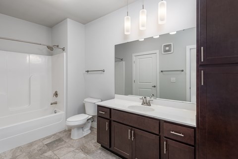 A bathroom with a white toilet, a white sink, and a white bathtub.