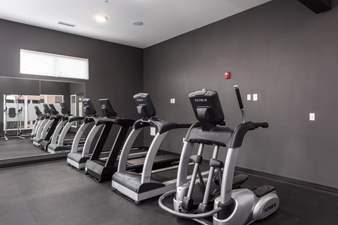 A gym with treadmills lined up.