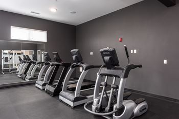 A gym with treadmills lined up.