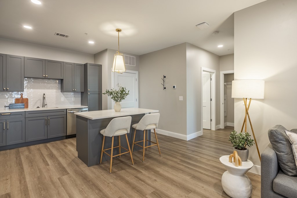 A modern kitchen with a dining area and a living area.at Preserve at Sycamore Creek, Osage Beach