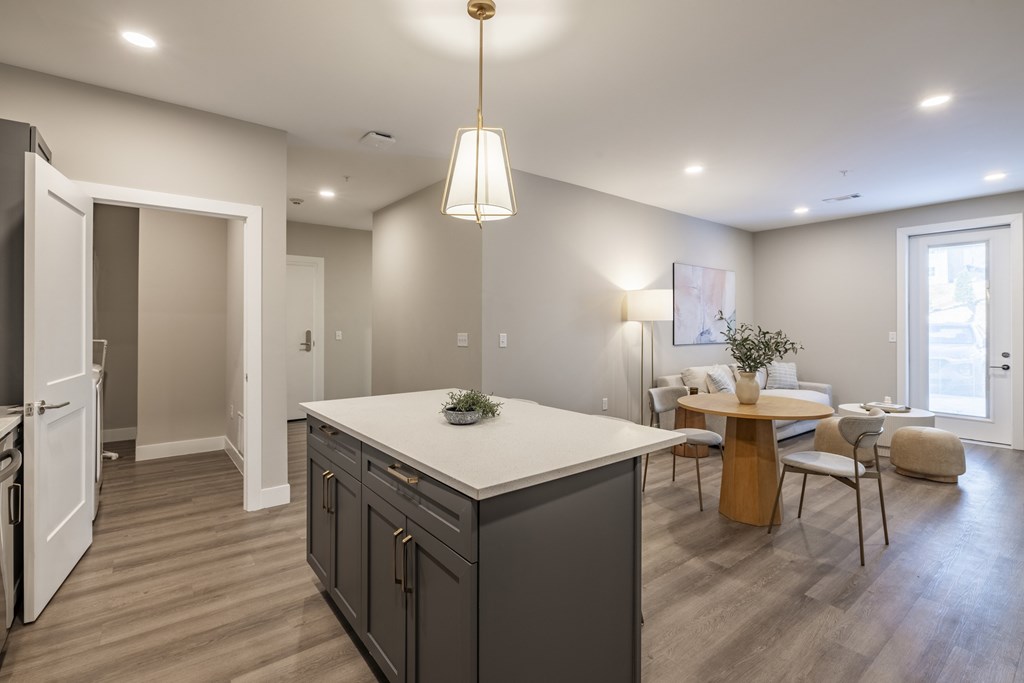 A modern kitchen with a large island and a dining area.at Sycamore Creek, Osage Beach, MO 65065
