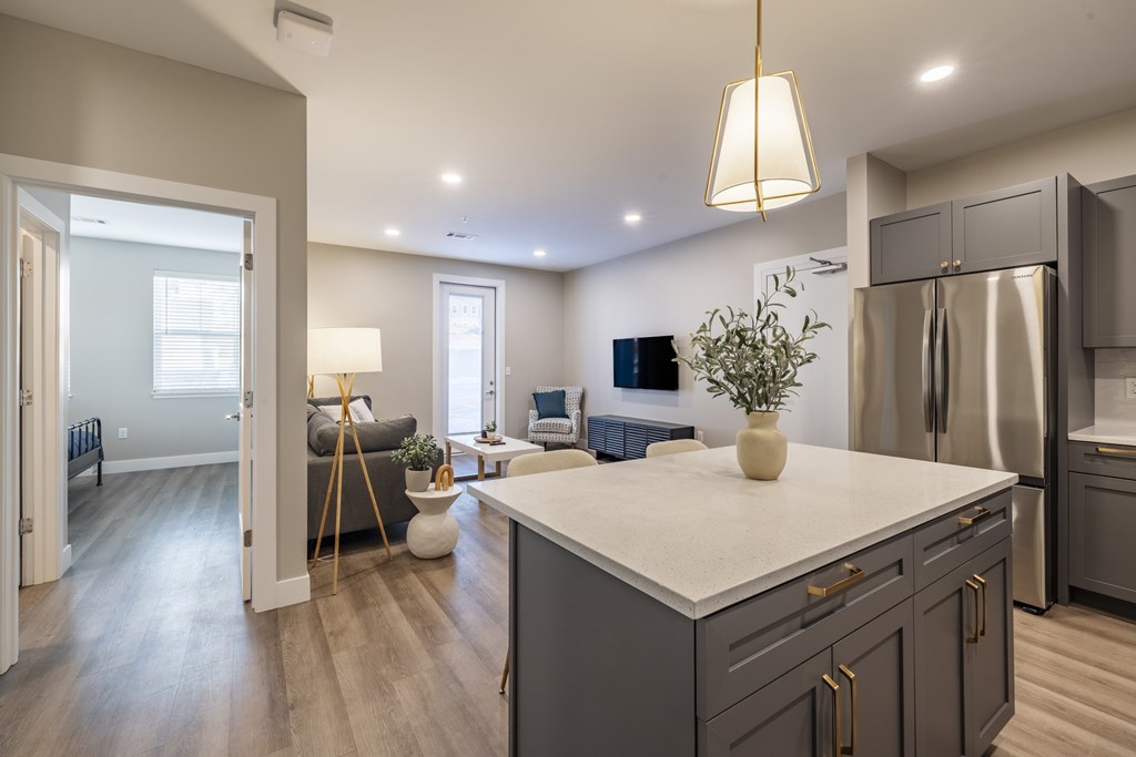 A modern kitchen with a large island and stainless steel appliances.at Preserve at Sycamore Creek, Osage Beach, MO