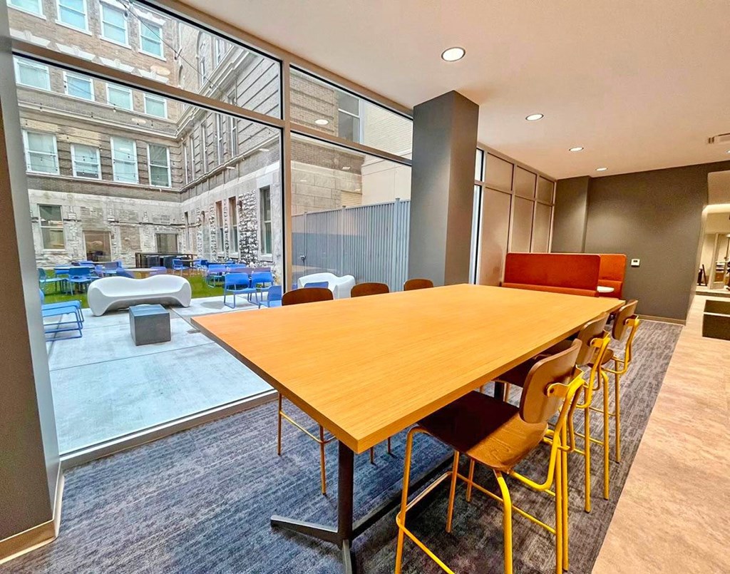 clubroom/resident lounge large work table overlooking courtyard  at The Residences at Delmar DivINe, St Louis, MO, 63112