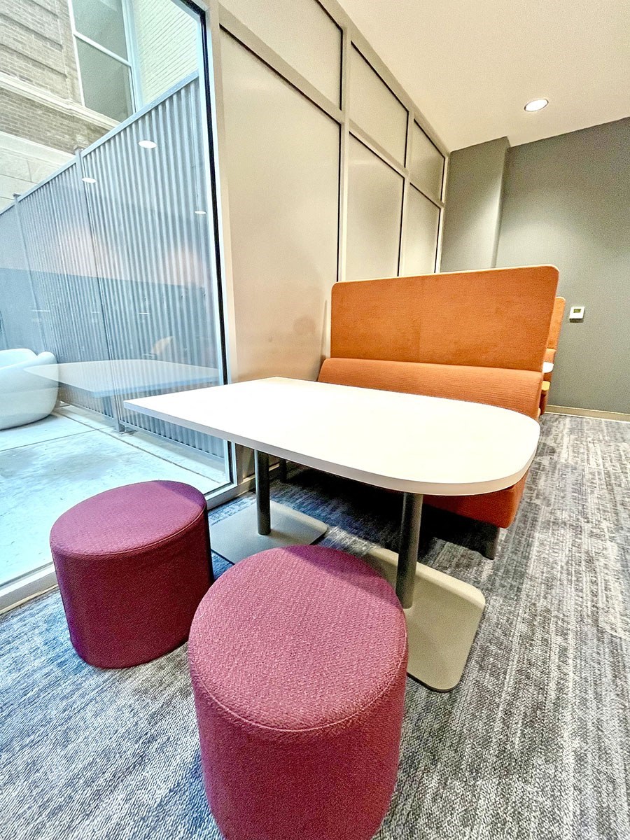 clubroom/resident lounge small work/study area with bench, table and modular seating  at The Residences at Delmar DivINe, St Louis, Missouri