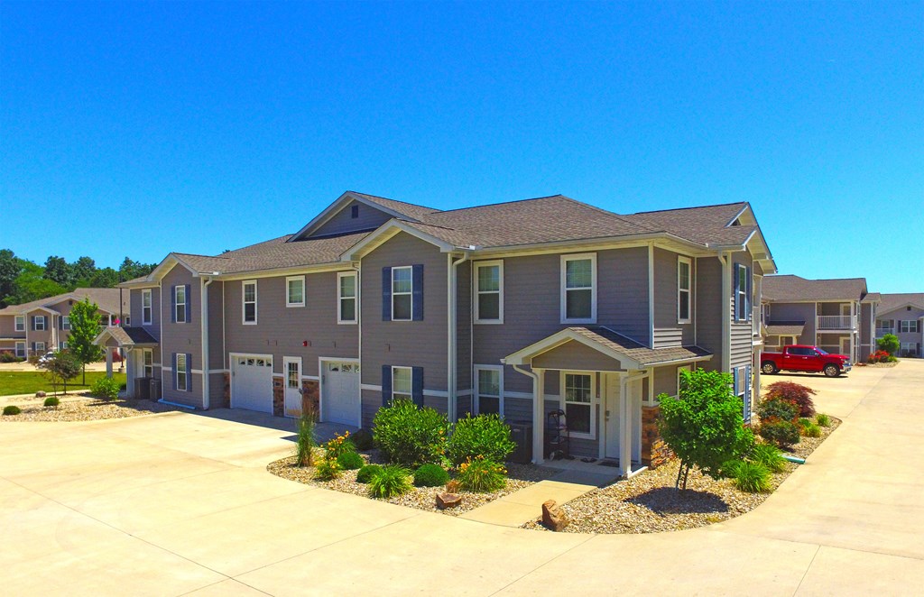 Concrete Drive. Building with gray siding.