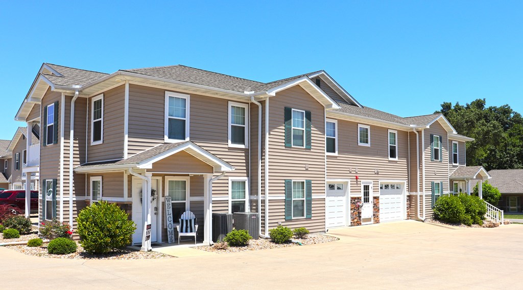 Concrete Drive Buiding Exterior with Gray Siding