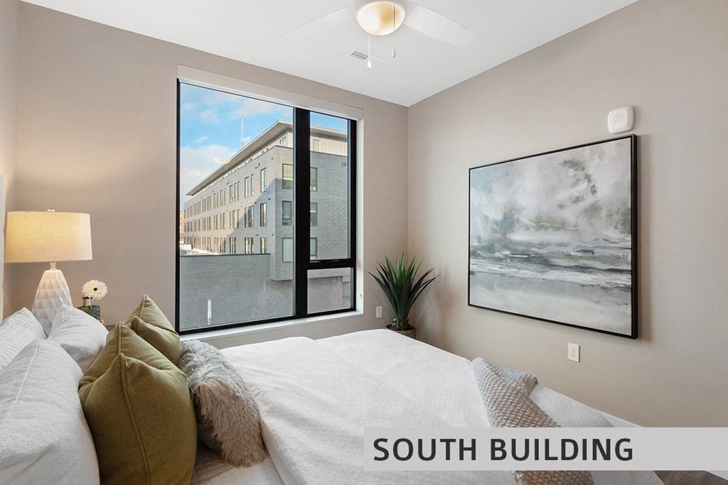 a bedroom with a large window and a ceiling fan  at Expo at Forest Park, St. Louis, MO, 63112