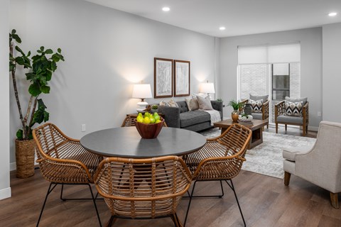A modern dining room with a round table and chairs.