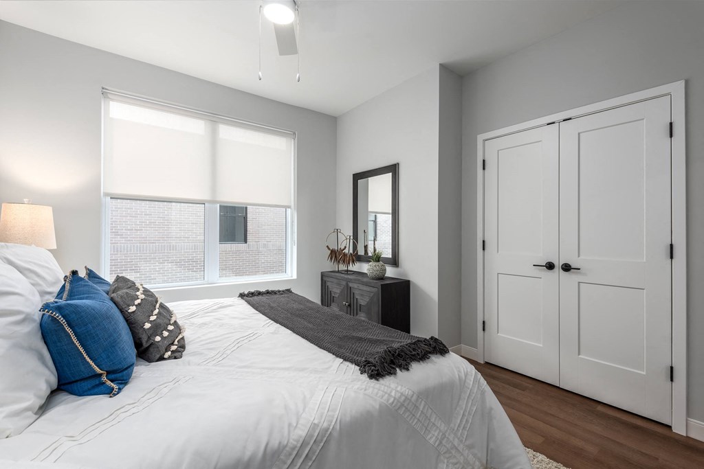 a bedroom with a large bed and a window