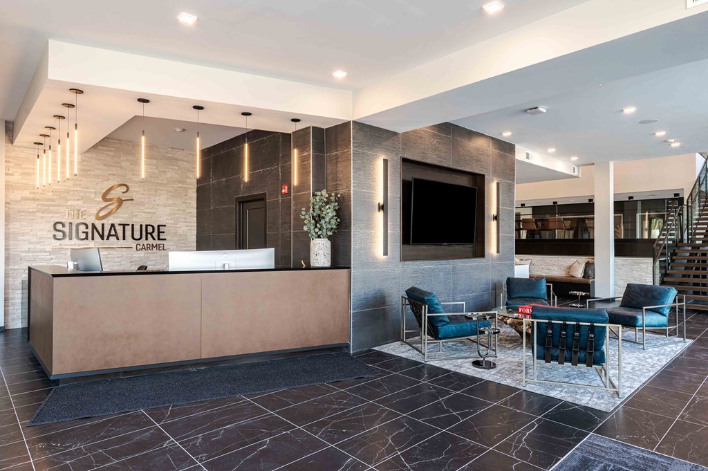 A reception area with a large desk and chairs.