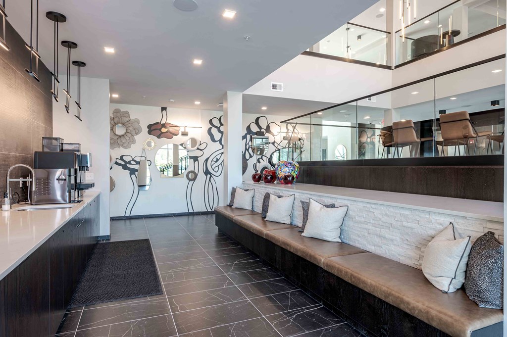 A modern kitchen with a long bench and a counter.