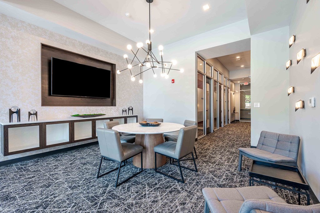 A modern dining room with a large table and chairs.