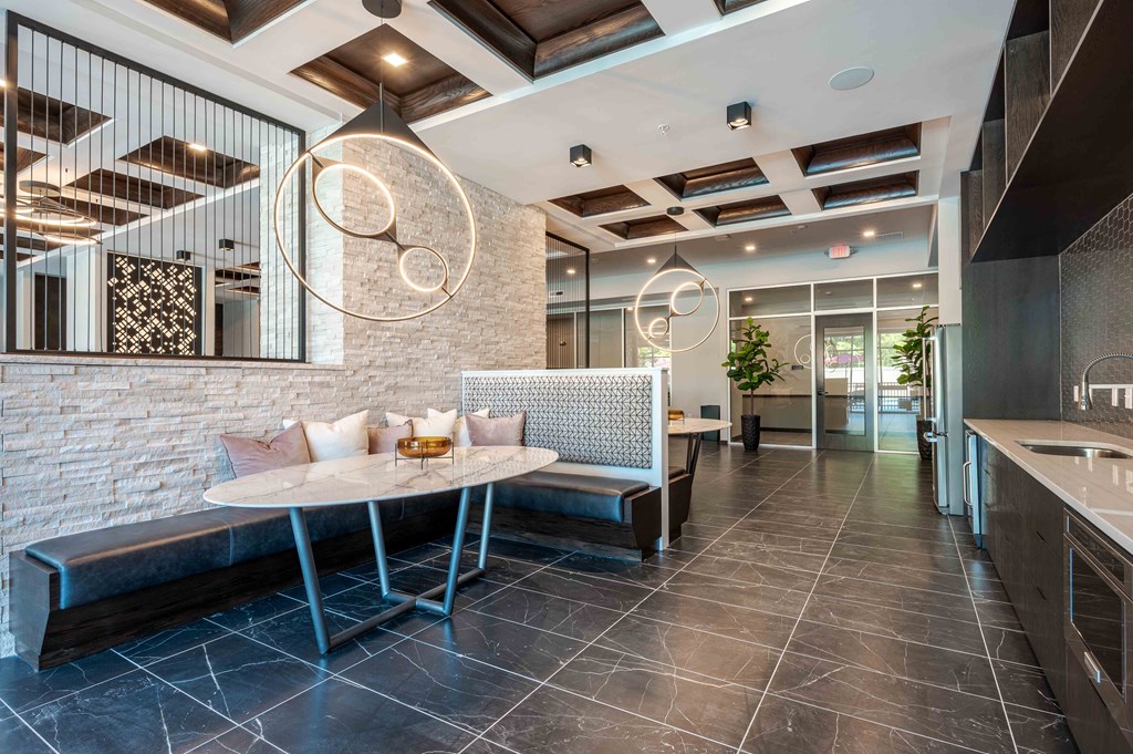 A modern dining area with a round table and a bench.