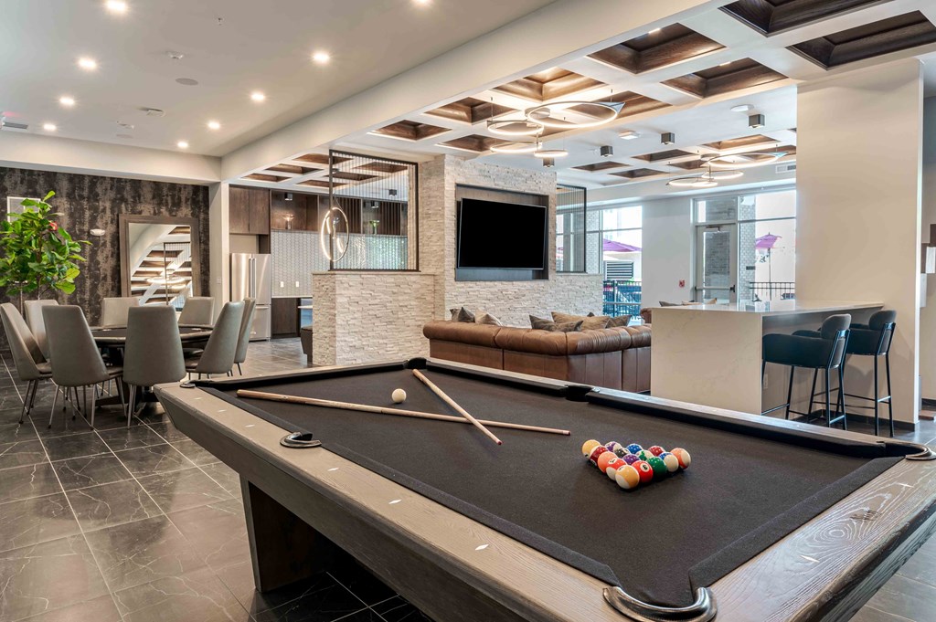A pool table with a white ball and a set of pool cues.