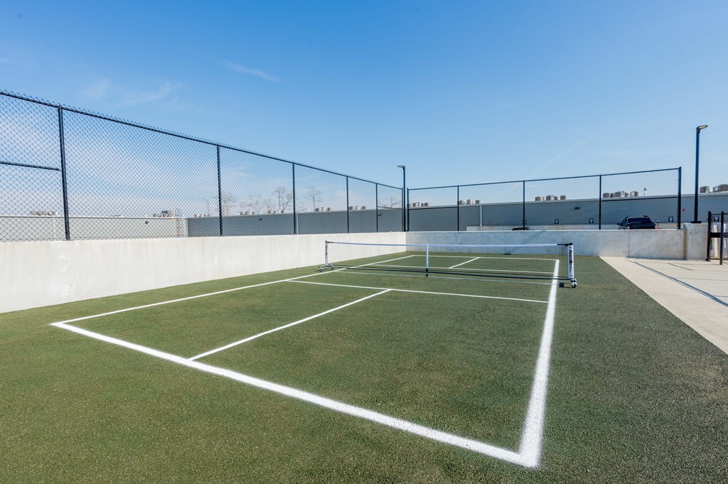 A tennis court with a white line in the middle of it.