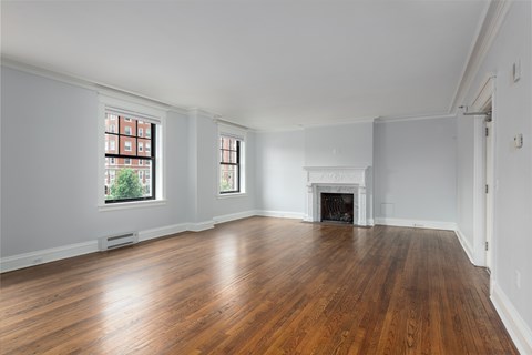 York House large living room with oak hardwood flooring, gas fireplace and crown molding.
