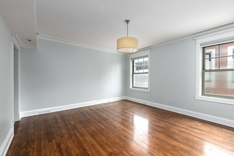 A room with wooden floors and a window.