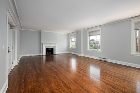 York House large living room with oak hardwood flooring, gas fireplace and crown molding.