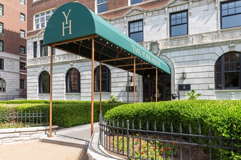 A building with a green awning that says Y.H.