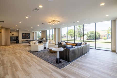 A spacious living room with a grey sofa and a coffee table.