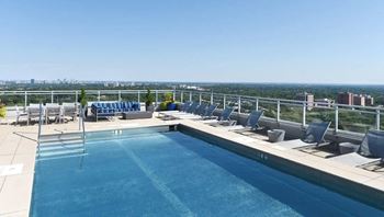 a swimming pool on the roof of a building with a city view  at Two Twelve Clayton, Missouri