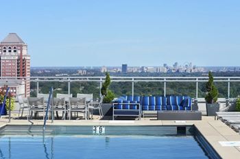 a pool on the roof of a building with a city in the background at Two Twelve Clayton, Missouri, 63105