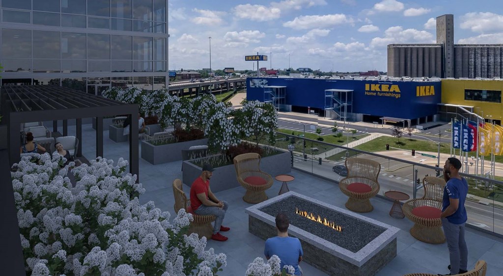 people sit around a fire pit on a rooftop patio  at One Foundry Way, St. Louis, 63110