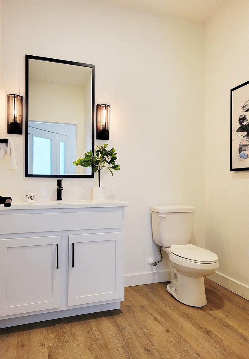 a bathroom with a toilet sink and mirror