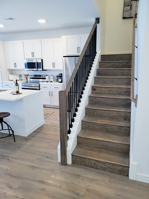 a view of the stairs from the living room into the kitchen