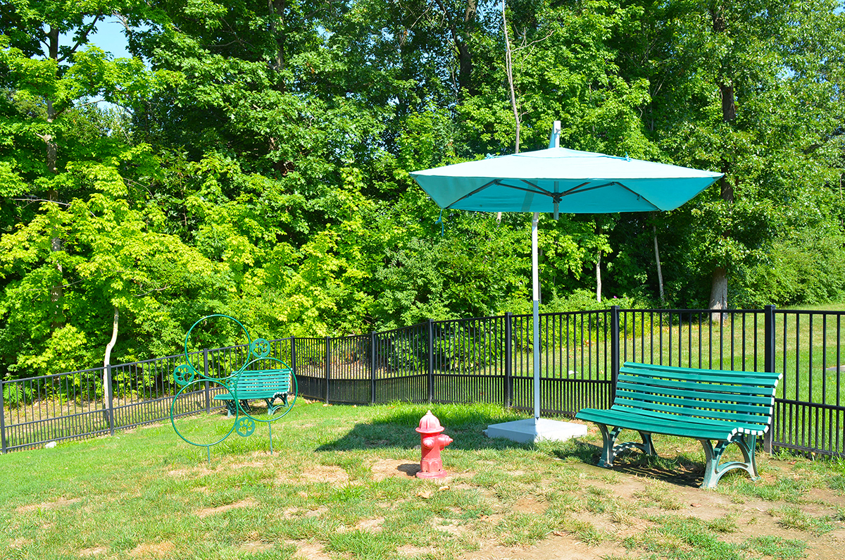fenced pet park with umbrella and bench at Villas At Crystal Lake, Swansea, 62226