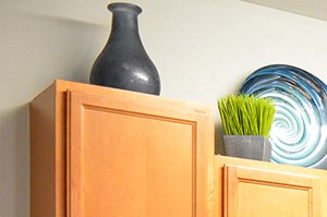 kitchen island with light wood cabinets and black fridge, range and microwave - Photo Gallery 5