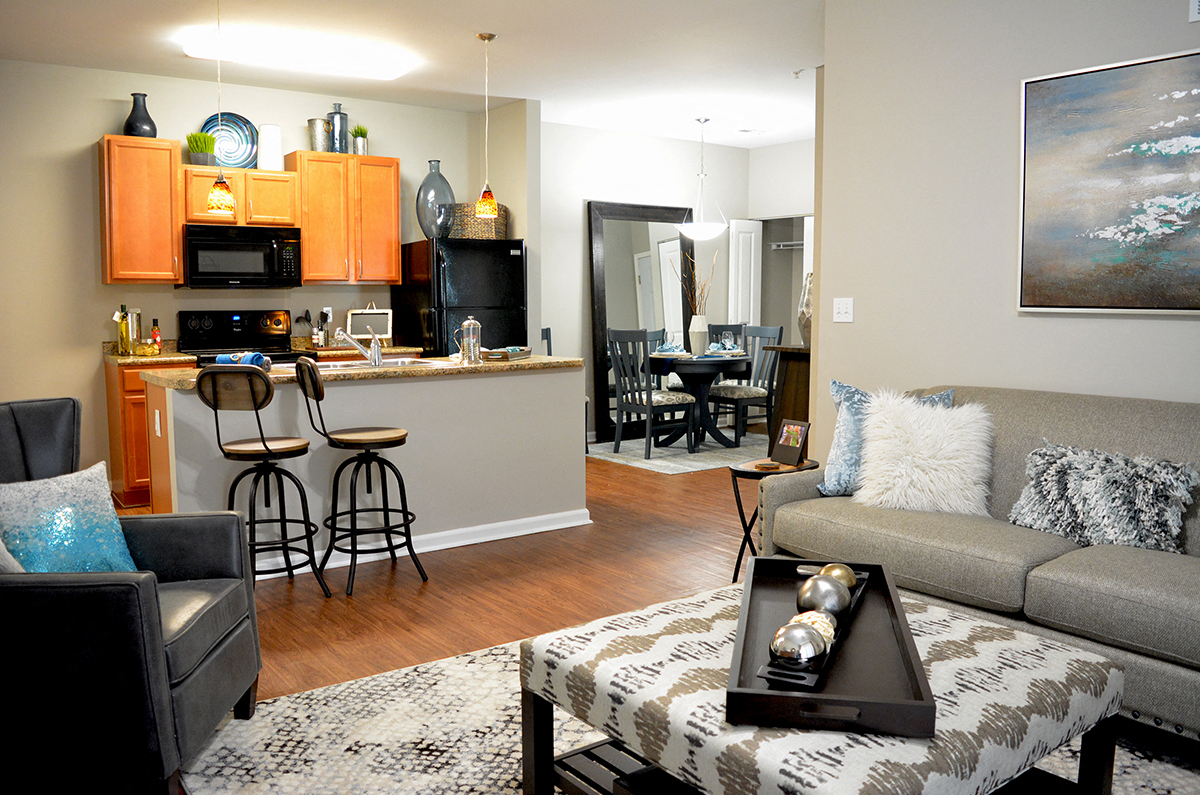 a living room and kitchen with a couch and a table