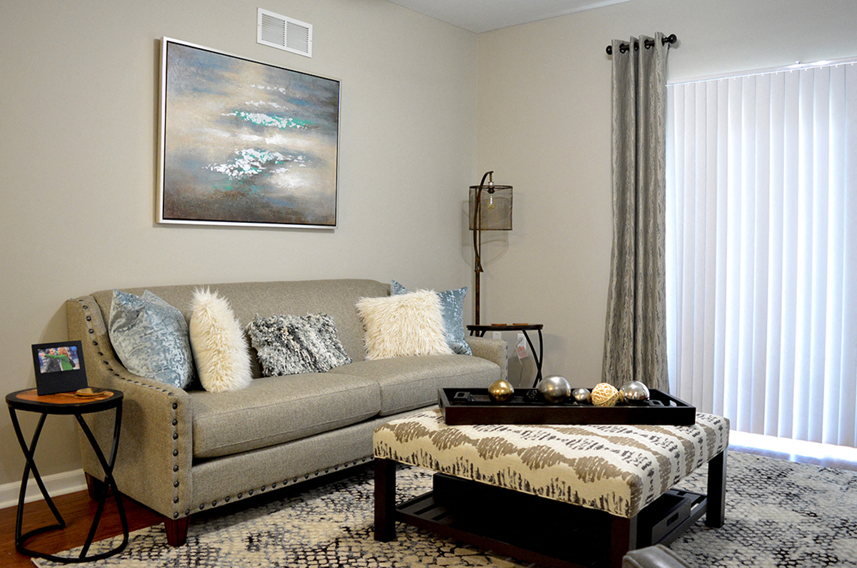 living room with gray couch and wall art at Villas At Crystal Lake, Swansea, Illinois