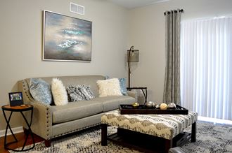 living room with gray couch and wall art