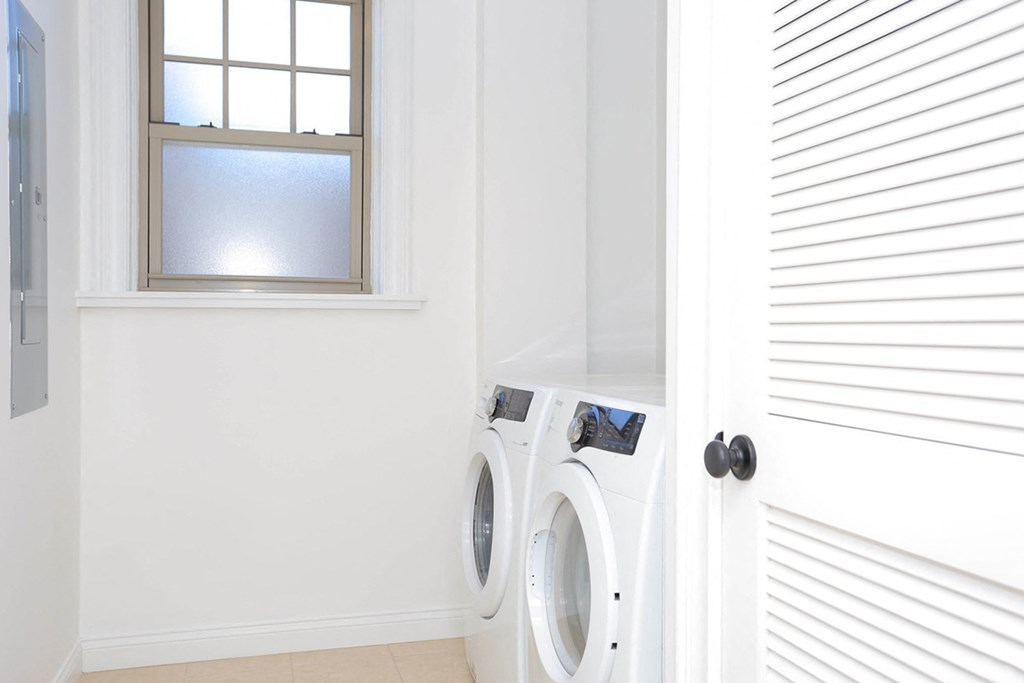 laundry room with side-by-side white washer and dryer at York House, Missouri, 63108