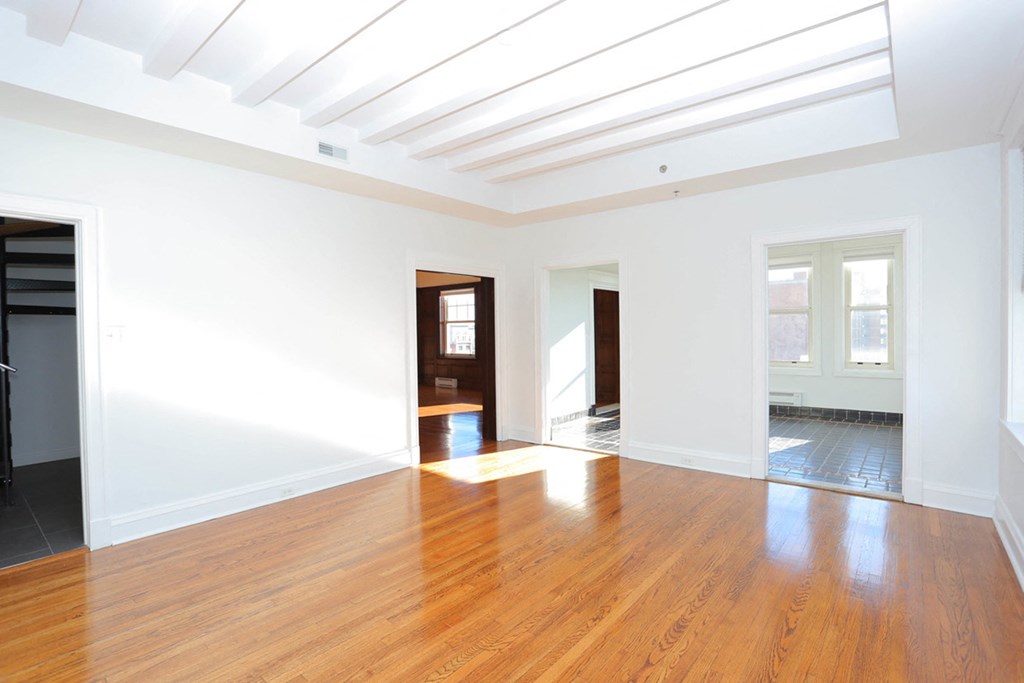 Penthouse living room with wood floorig and white walls at York House, Saint Louis, Missouri