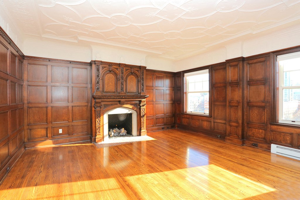 York House penthouse living room with hardwood floors, fireplace and wood panelling at York House, Saint Louis, 63108