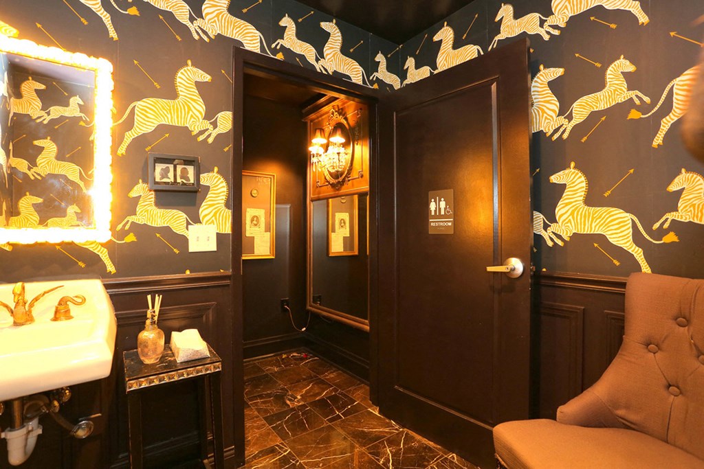 York House lobby restroom with zebra wallpaper and gold faucet at York House, Saint Louis, Missouri