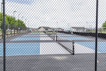 A chain link fence surrounds a pool.