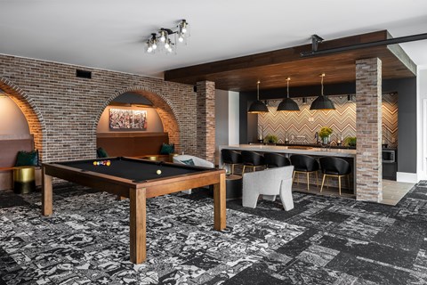 Modern resident clubroom with pool table and lounge kitchen  at Chapter at the Streets of St Charles, Saint Charles, MO, 63303