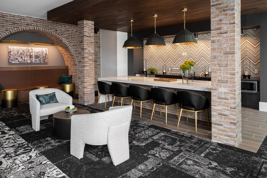 Modern resident lounge with clubroom kitchen and conversational seating  at Chapter at the Streets of St Charles, Missouri, 63303